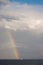 A boat, and a rainbow above the sea in Sydney