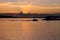 The boat returns to the pier at sunset, which sets in clouds. Lake VesijÃ¤rvi. Lahti. Finland