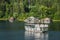 Boat ride on the lake - houses on the lake shore and forest behind - Bicaz lake, Romania, 31-07-2021