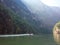 A boat rides down the Sumidero Canyon as sunlight bursts through in the morning in Chiapas State