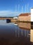 A boat and it`s reflections next a cottage in Topsham, Exeter