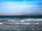 Boat sailing along the Cantabrian Sea with cliffs in the background