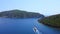 Boat sailing in bay and coming close to passage to enter in open sea. Aerial view