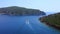 Boat sailing in bay and coming close to passage to enter in open sea. Aerial view