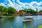 Boat sailing on blue lake and panoramic view of Germany and Italy Pavilions at Epcot in Walt Disney World .