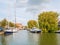 Boat sailing in harbour of old town of Makkum, Friesland, Nether