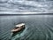 A boat sailing over calm sea waves