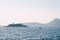 Boat sails along the Kotor Bay against the backdrop of Mamula Island. Montenegro