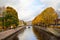 The boat sails on the Griboyedov canal to the Staro-Nikolsky bridge in autumn