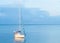 Boat sails on river and casts orange glowing reflection