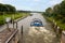 A boat sails through the sluice at the river `the Maas