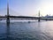 The boat sails under the Golden Horn Bridge in Istanbul Turkey. Beautiful seascape with modern railway bridge in turkish tourist