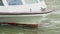 The boat sails through the water, close-up shows the front of the boat