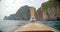 The boat sales through the waves to the mountain lagoon of Phi Phi island