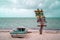 Boat on a sandy beach with directions signs on a trunk and the Caribbean sea in the background