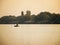 Boat on the scenic river with fisherman at sunset