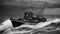 boat in the sea black and white photo of A scary sport fishing boat in a sea of blood, with storms,