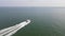 Boat on a sea in The Netherlands near Vlissingen, following at high speed on a sunny day.