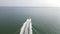 Boat on a sea in The Netherlands near Vlissingen, following at high speed on a sunny day.