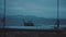 Boat in the sea over cloudy dark sky