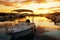 Boat in sea port at colorful sunset.