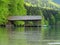 Boat shed at mountain lake and forest, spring season nature