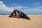 boat ship skeleton grunge half buried in brown sand in La Pedrera, Rocha, Uruguay