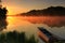 Boat on the shore of a misty lake