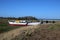 Boat on shore and old railway bridge, Condor Green