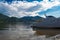 the boat is on the shores of lake teletskoye. white clouds on blue sky