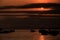 Boat Silhouettes Rest on Ocean Surface in Darkness at Sunset