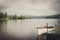 A boat sits on Blue Mountain Lake in a moody summer scene in the Adirondack Mountains.