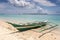 a boat sitting on top of a sandy beach on bantayan island in the Philippines