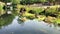 Boat slowly passing by on small river with moss and green curb