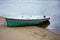 boat with stripes on the shore behind water