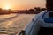 The boat swims into the sunset. Sunset in the city of El Gouna. Waves on the water