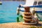 A boat tied to a pier on bright summer day with blue sea or ocea