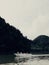 Boat with tourists floating near huge rocks in National Park