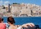 Boat with tourists in harbor of Valletta city with fortified walls. Malta landscape