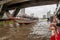 Boat traffic on the Chao Phraya River in central Bangkok, Thailand, near the Taksin bridge and the Sathon Pier