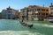 a boat traveling down a river surrounded by old buildings and a canal