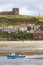 Boat Travelling up The River Esk at Whitby with St Mary`s Church in the Background.