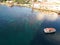 Boat travels over clear sea and coral toward shore