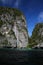 Boat trip around impressive steep rough cliffs of tropical island Ko Phi Phi, Thailand