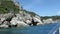 Boat trip from Paleokastritsa towards Liapades beach at Corfu Island Greece. passing by sediment chalk rocks in the water. Cliff