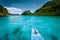 Boat trip to tropical islands El Nido, Palawan, Philippines. Steep green mountains and blue water lagoon. Discover