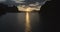 Boat trip on water surface of a tropical lake, mountains, cliffs and rocks on sunset background, Khao Sok National Park, Surat Tha