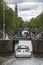 Boat under bridge over a canal in Amsterdam