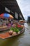 Boat vendor selling roses and pandan leaves at floating market around Bangkok area