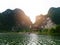 The boat that was paddling along the waterway with high mountains